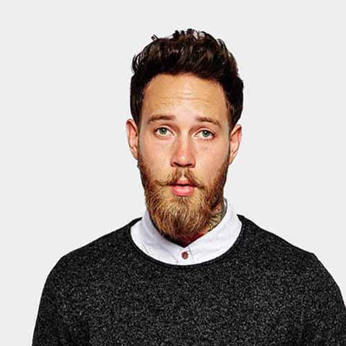 A team photo of four professionals standing side by side, all wearing business attire and smiling at the camera.